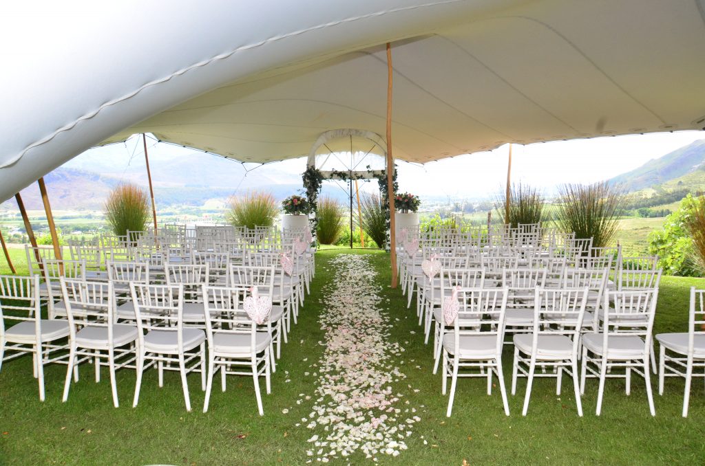 white-stretch-tent-backyard-wedding White Stretch Tent with Wooden Poles for Backyard Wedding