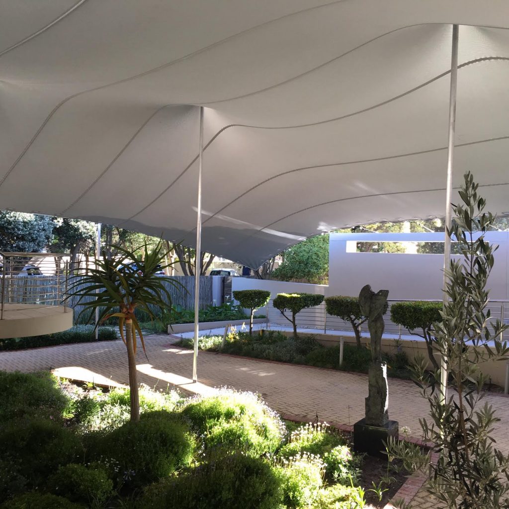Building-adjacent-stretch-canopy White Stretch Tent over Garden